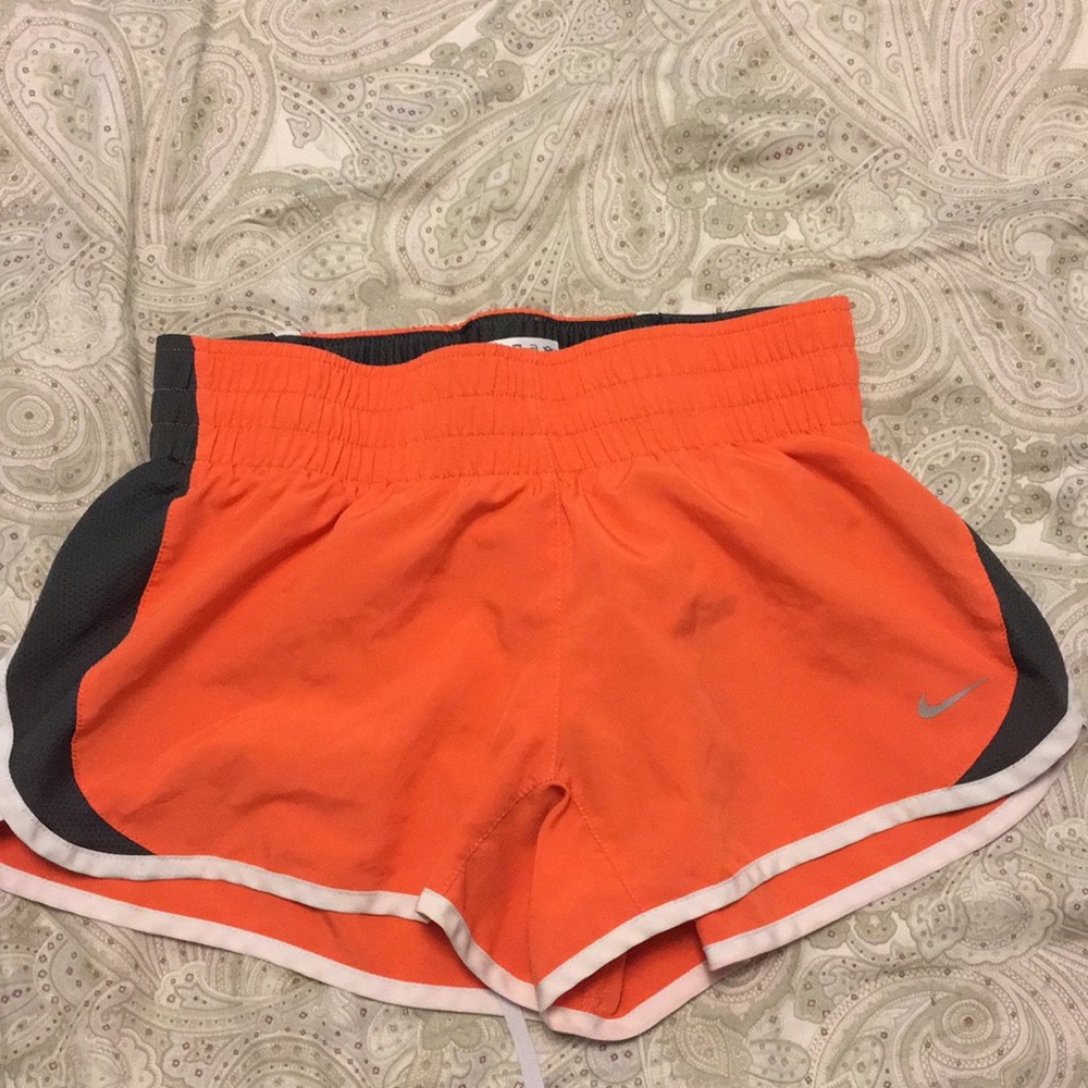 Orange Nike running shorts